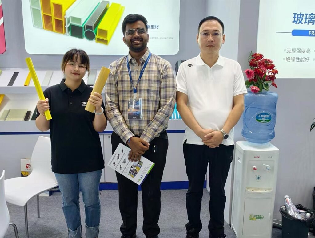 A group photo in front of the pultruded profiles
